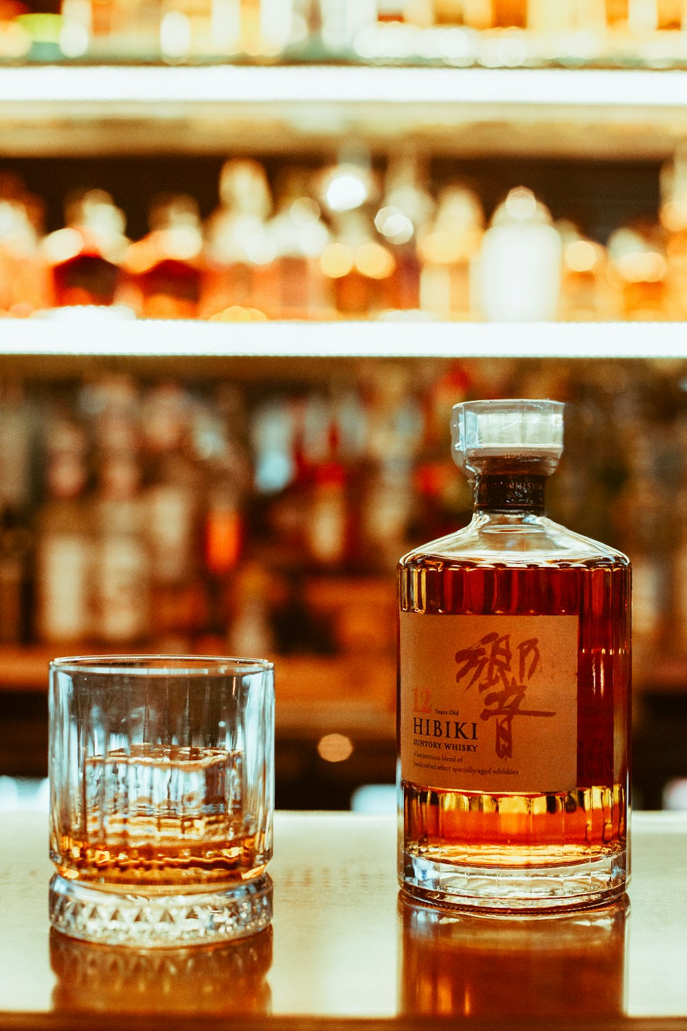 a bottle of whiskey sitting next to a shot glass