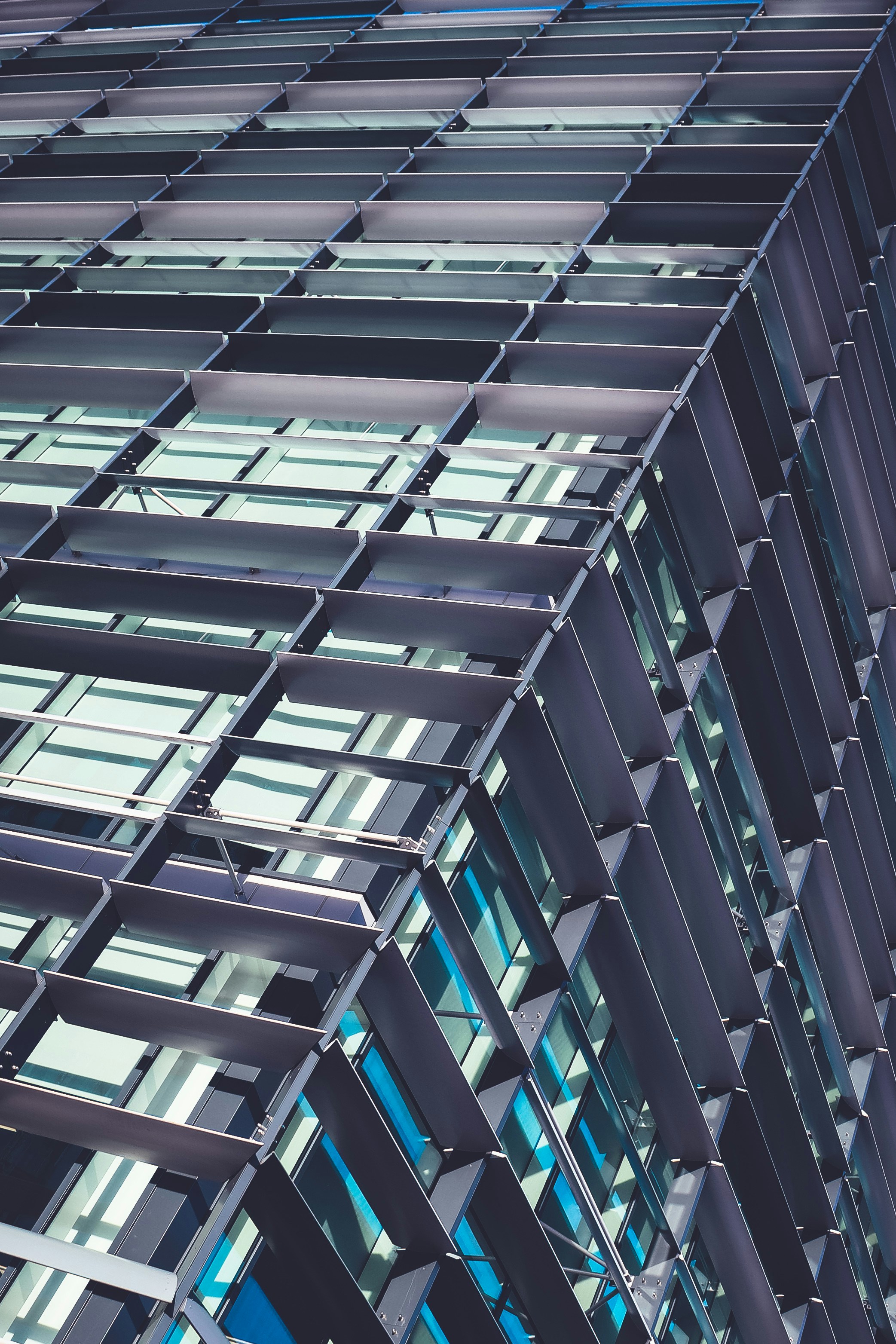 Custom decorative metal facade panels with geometric cutout patterns on a modern commercial building exterior