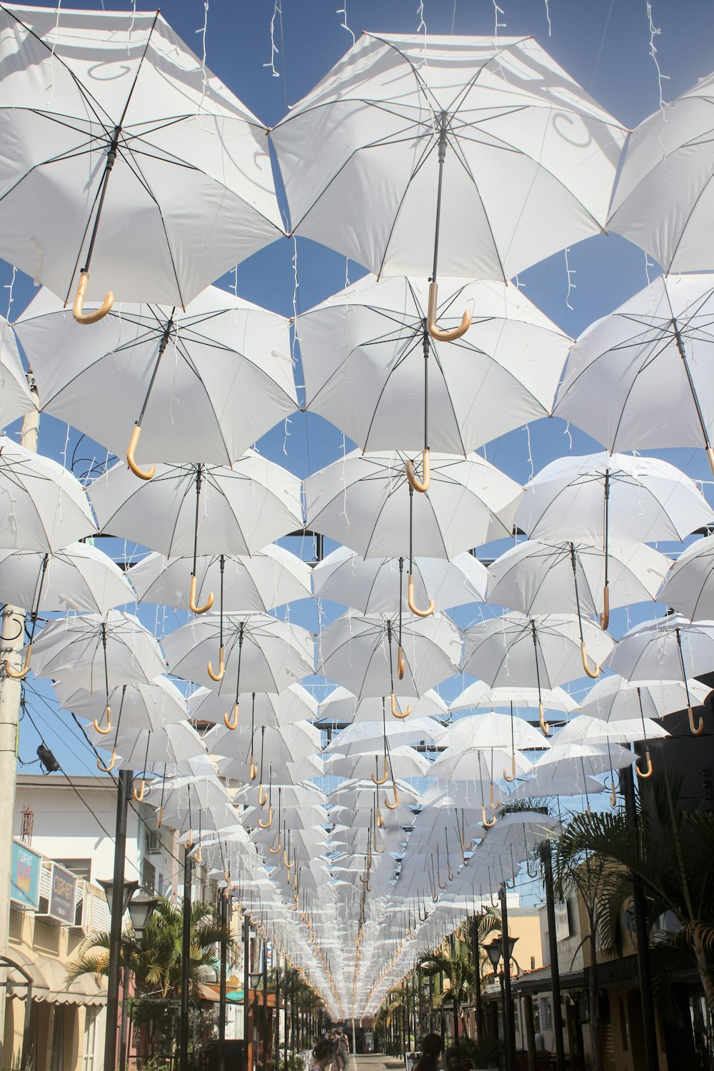 a group of white umbrellas hanging from the ceiling
