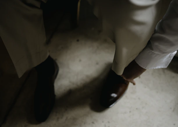 A skilled worker inspecting high-quality shoes on the factory floor.