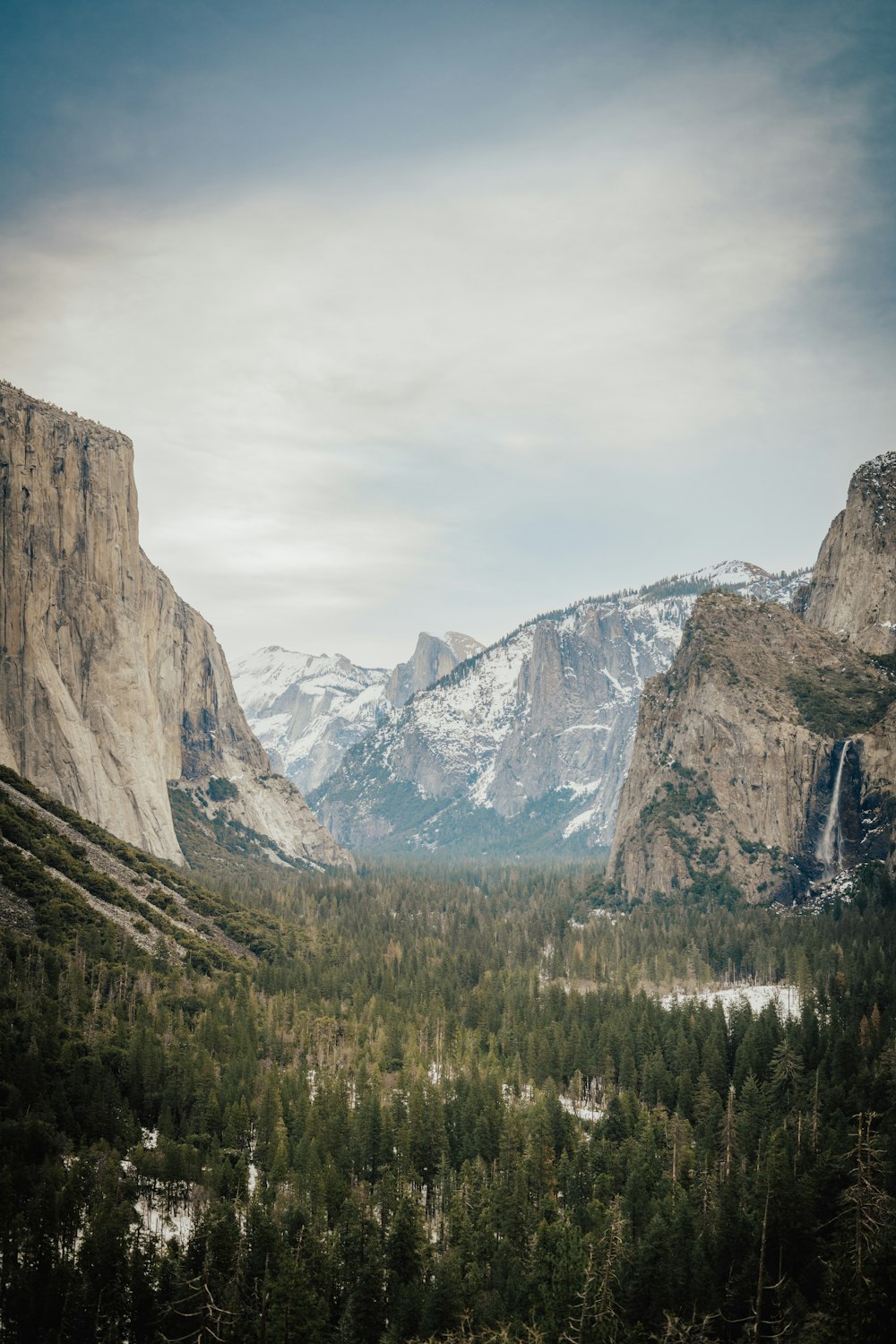 a view of a valley with mountains in the background