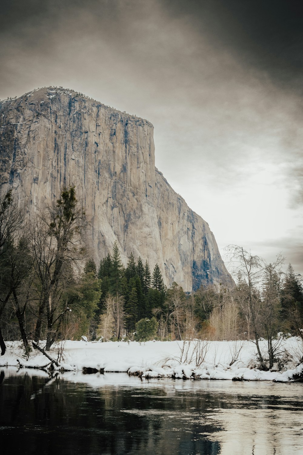 a body of water with a mountain in the snow