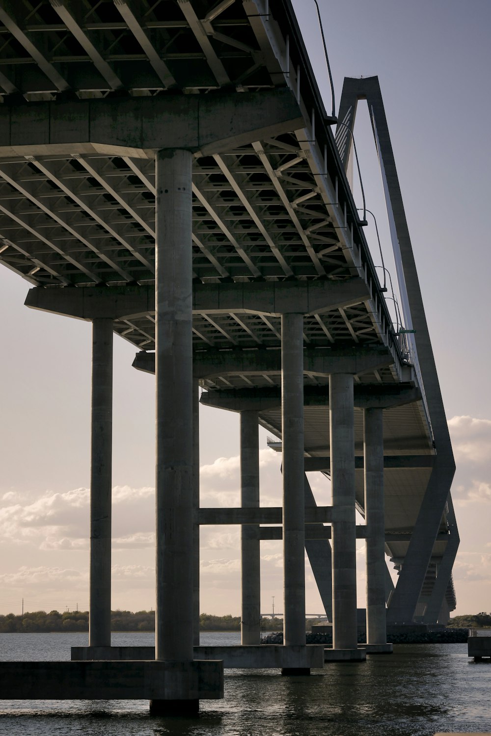 the underside of a bridge over a body of water