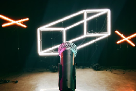 a microphone in a dark room with neon lights