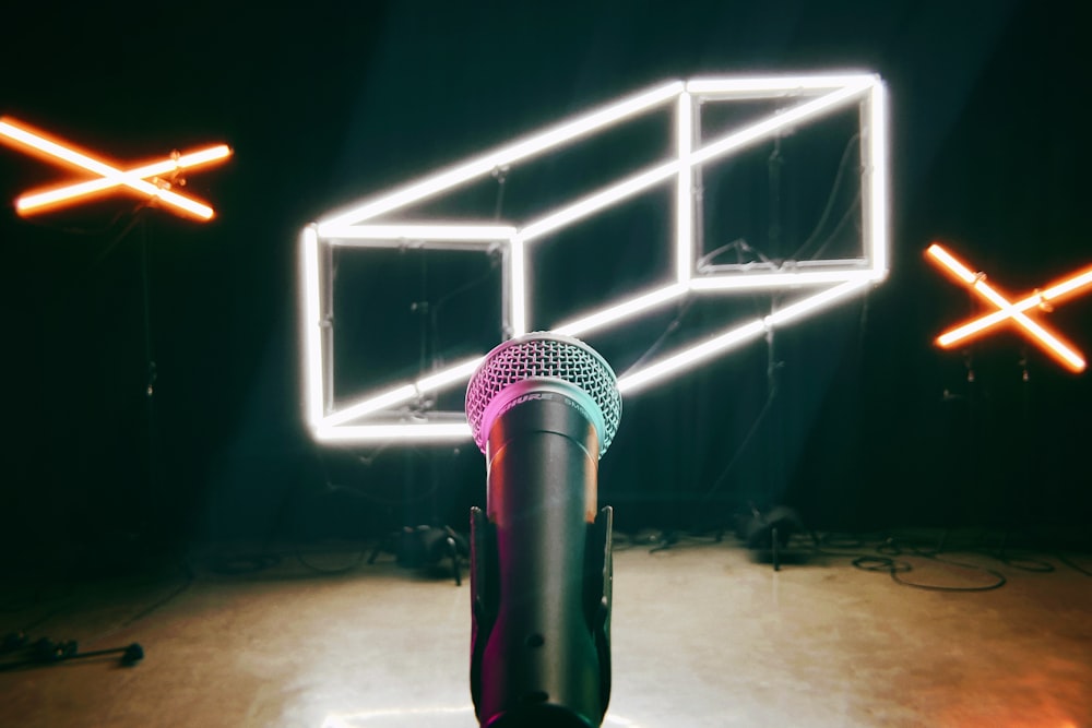a microphone in a dark room with neon lights