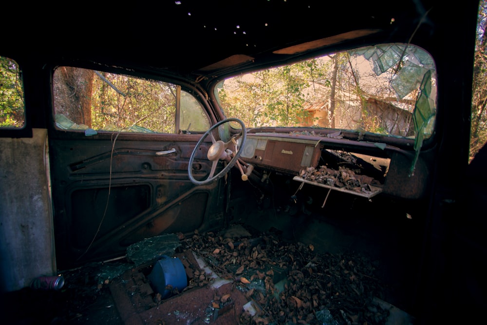 the interior of an old car with a bunch of junk