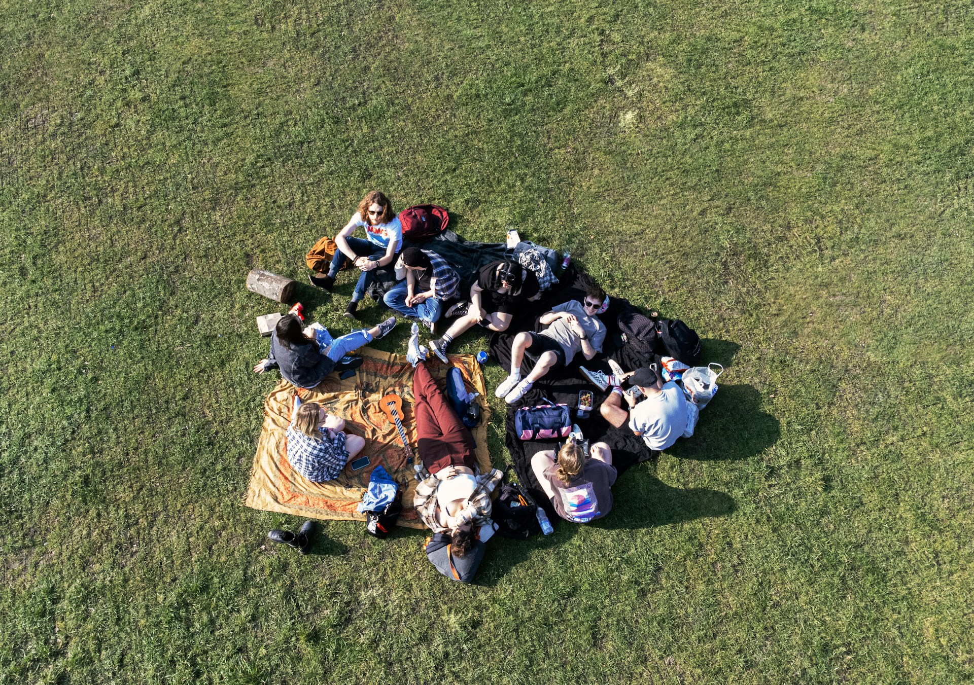 A group of friends enjoying a casual outdoor picnic in comfortable athleisure outfits.