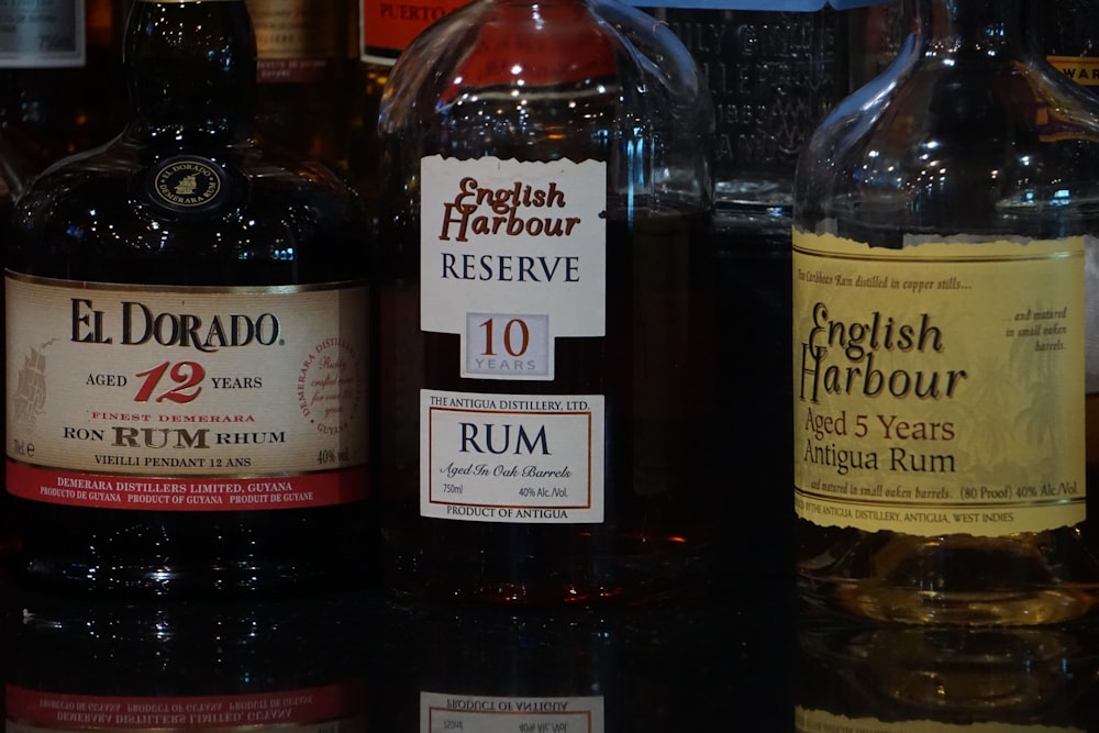 a close up of three bottles of liquor on a table