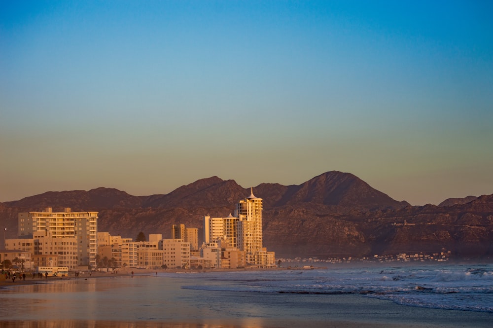 a view of a beach with mountains in the background