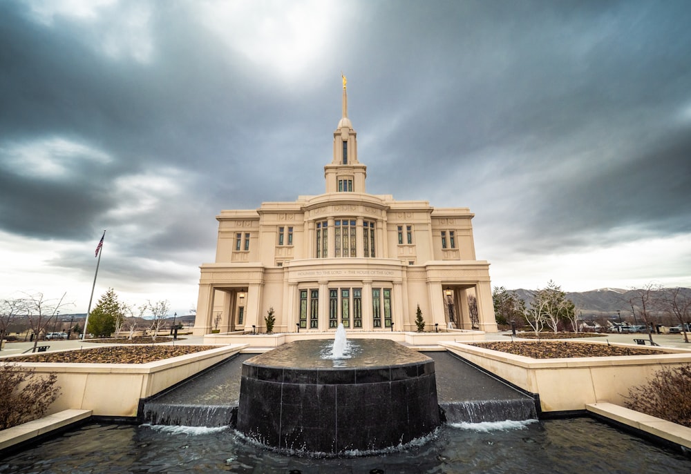 a large building with a fountain in front of it