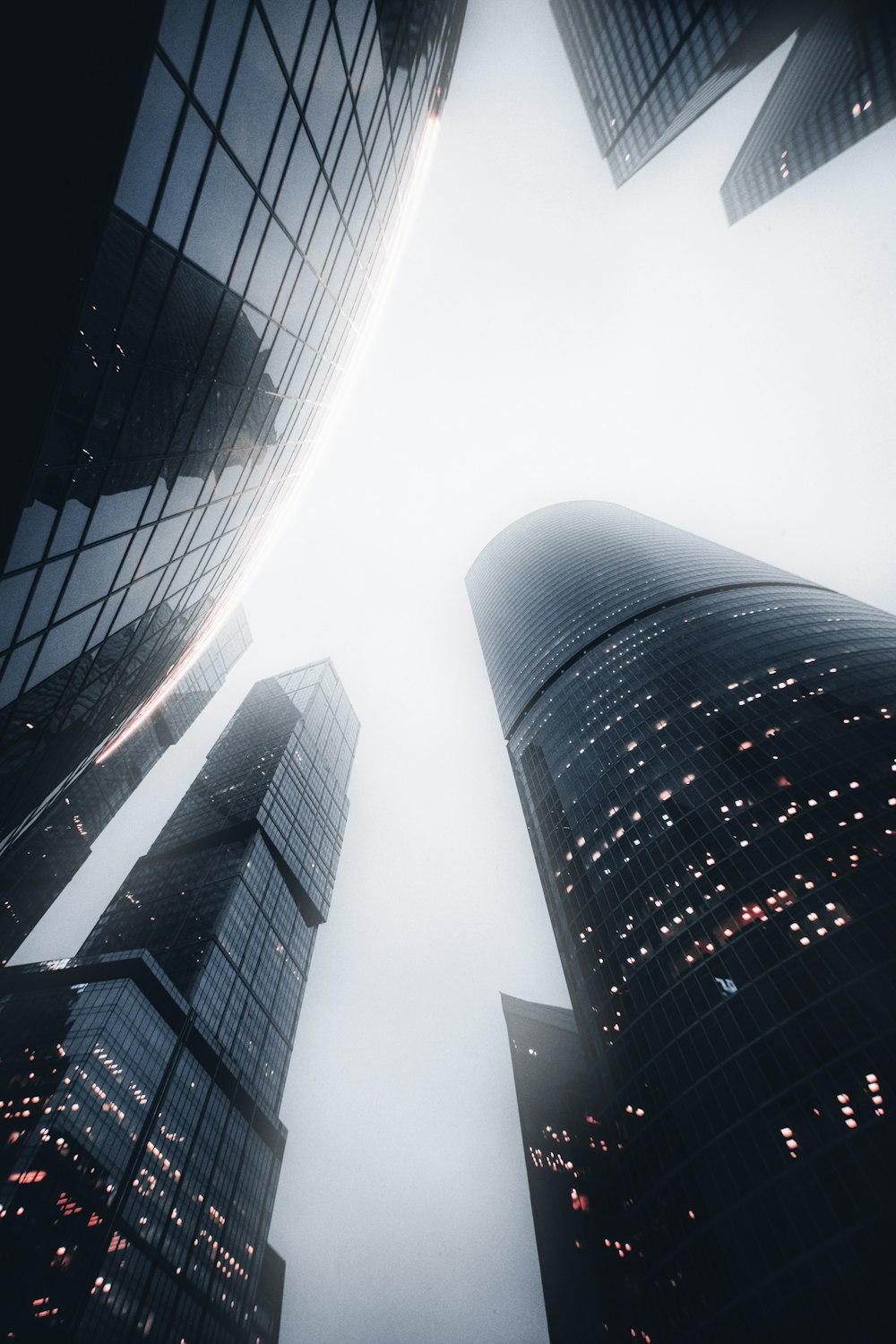 a group of tall buildings in a foggy city