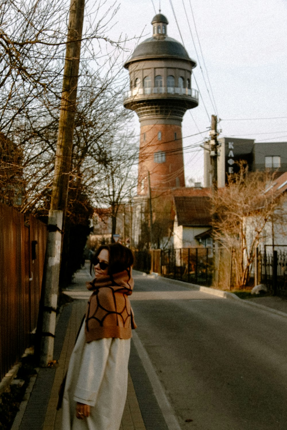 a woman standing on the side of a road