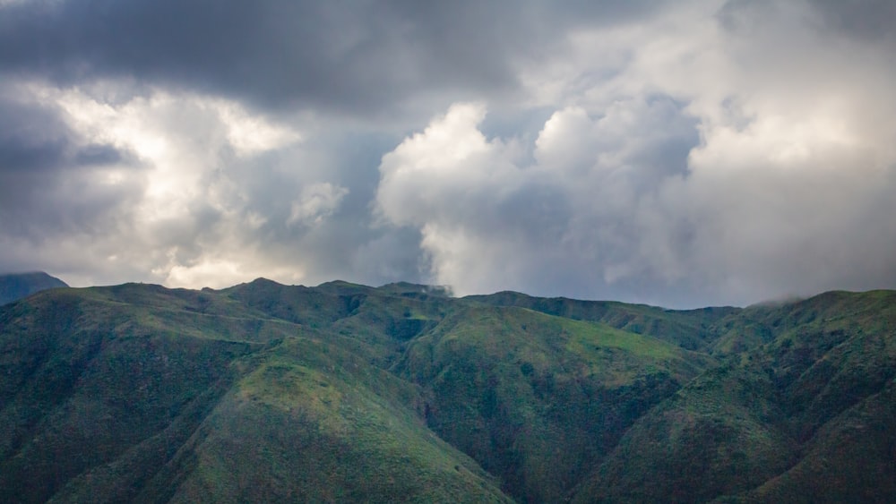 a view of a mountain range under a cloudy sky