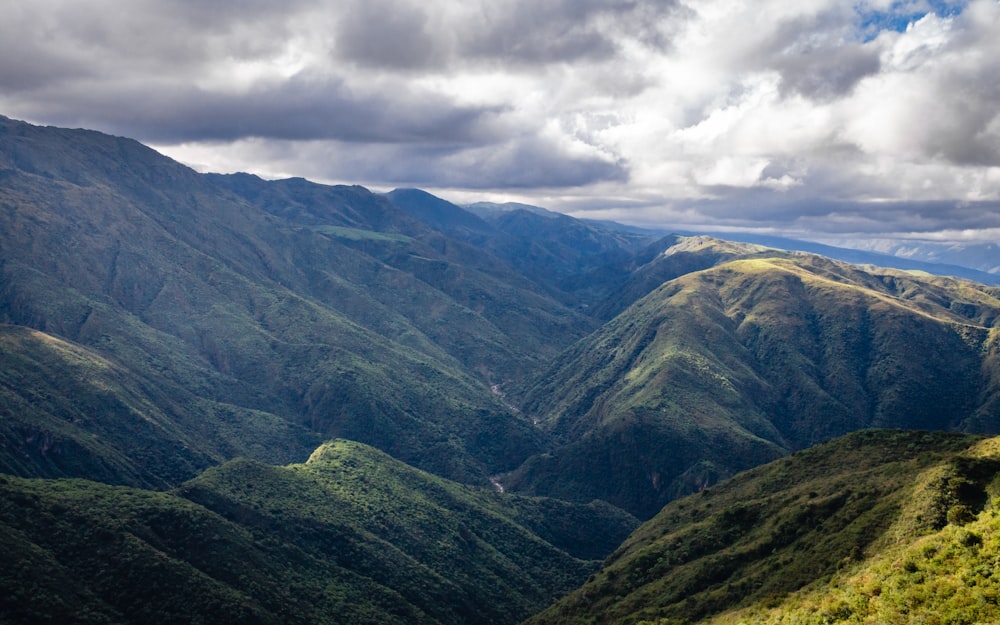 a view of a valley with mountains in the background