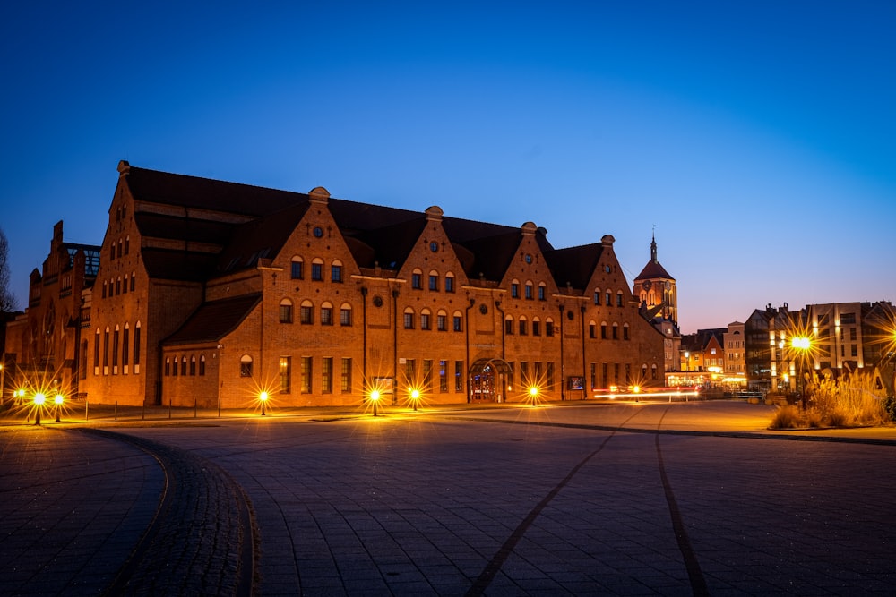 a large building lit up at night in a city