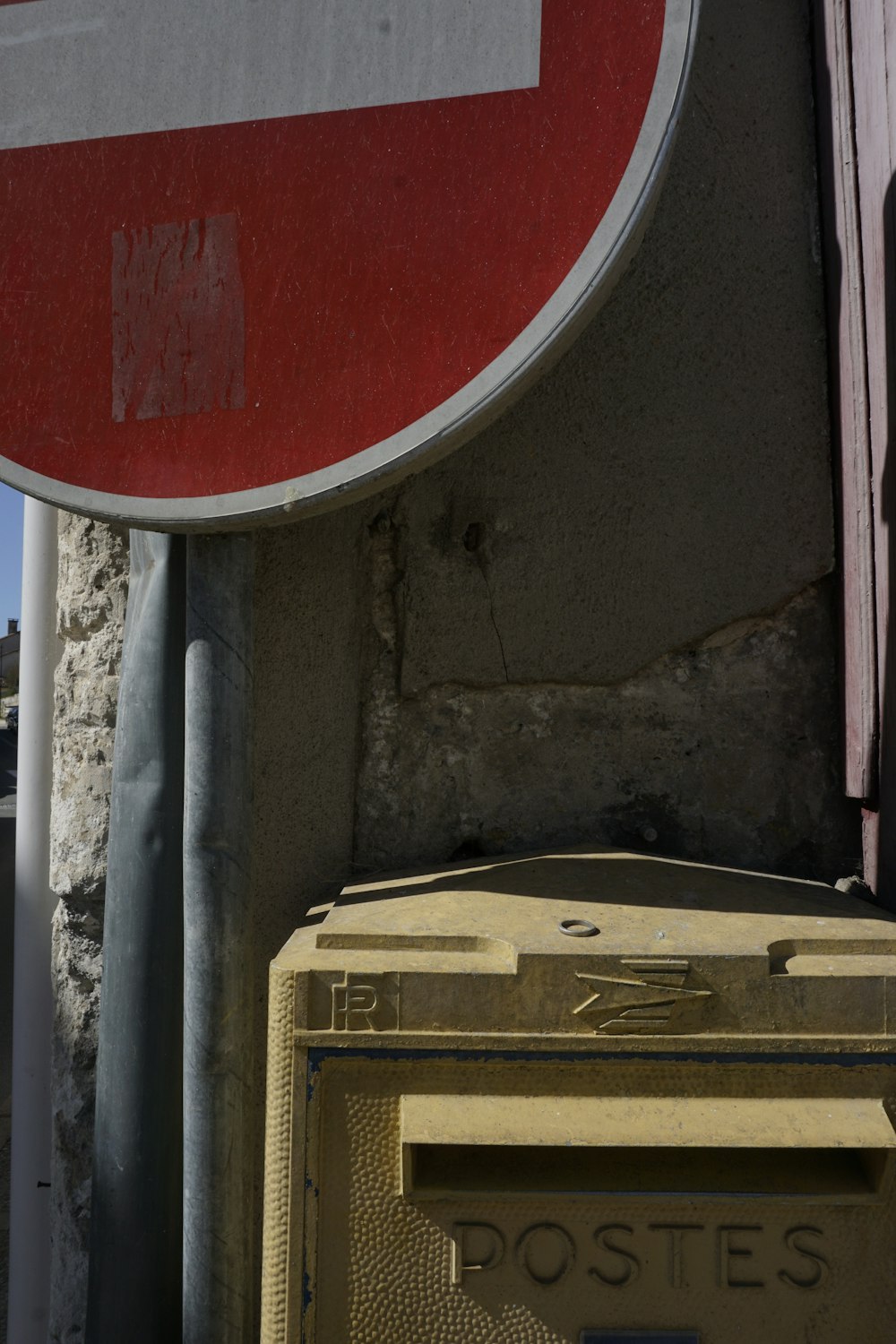 a close up of a street sign with a building in the background