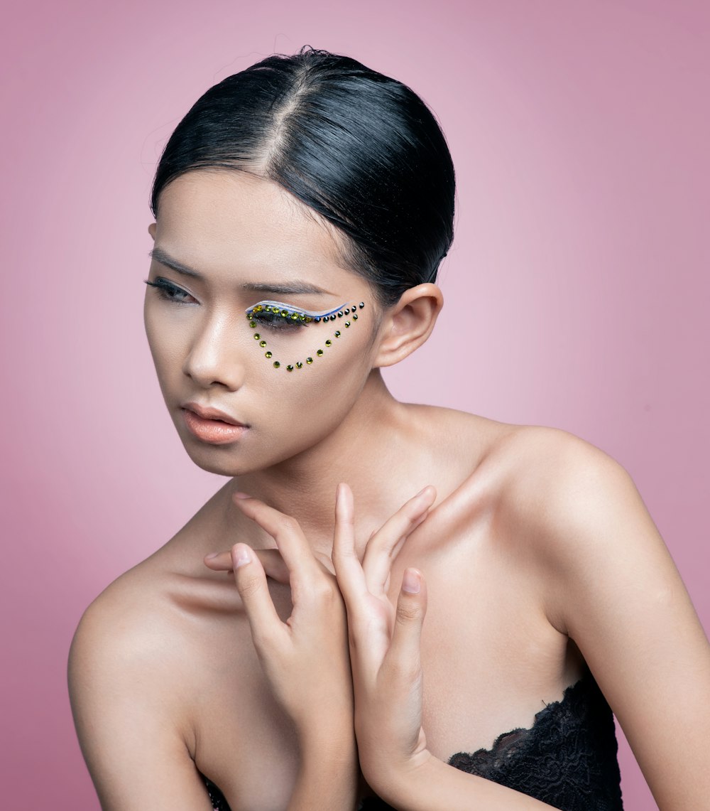 a woman with a black dress and a face paint