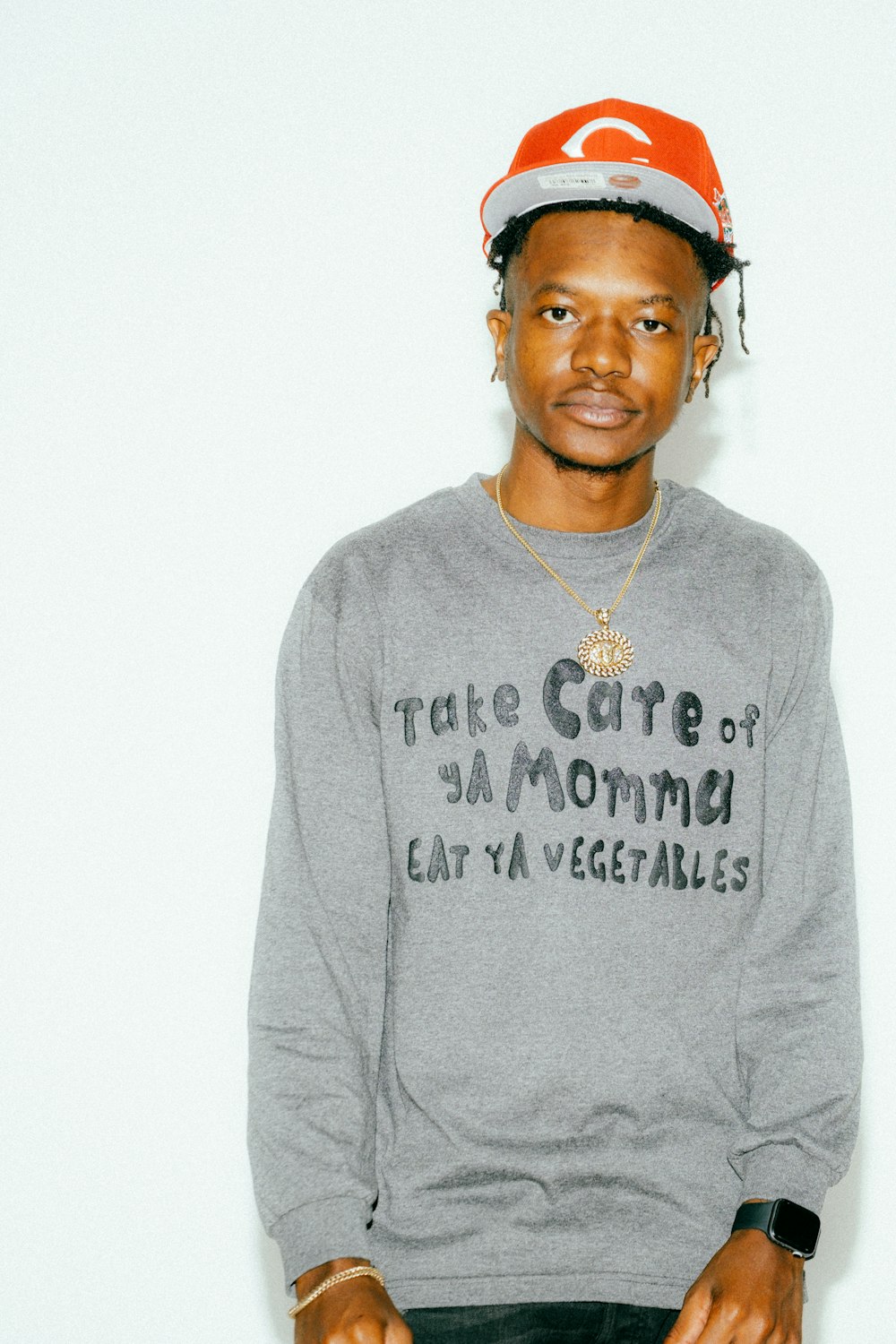 a young man wearing a hat and a sweatshirt