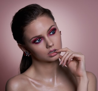 A close-up of a woman looking thoughtful, with subtle red and blue highlights enhancing the white backdrop.