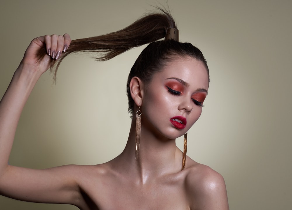 a woman with red lipstick and a ponytail