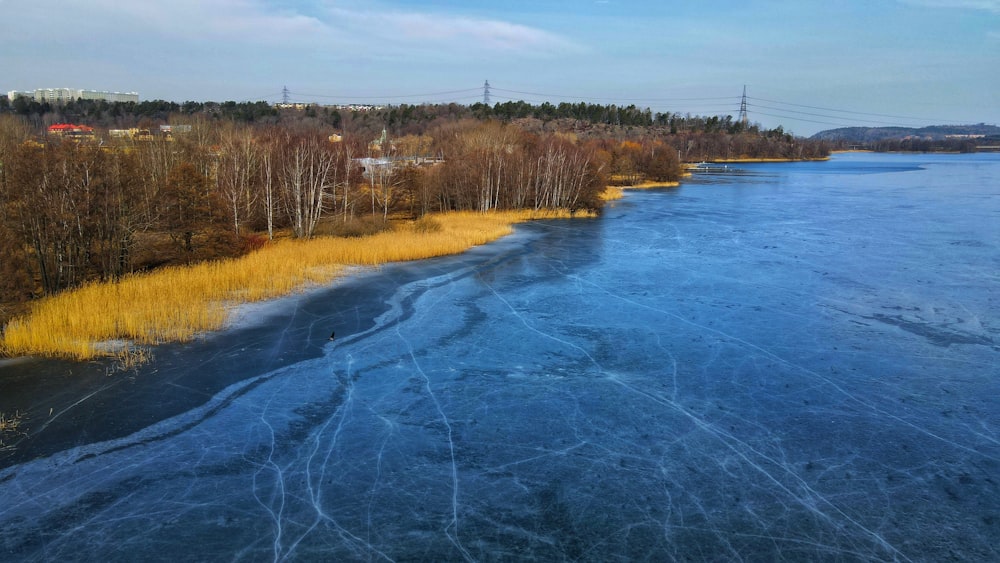 an aerial view of a river with ice on the water