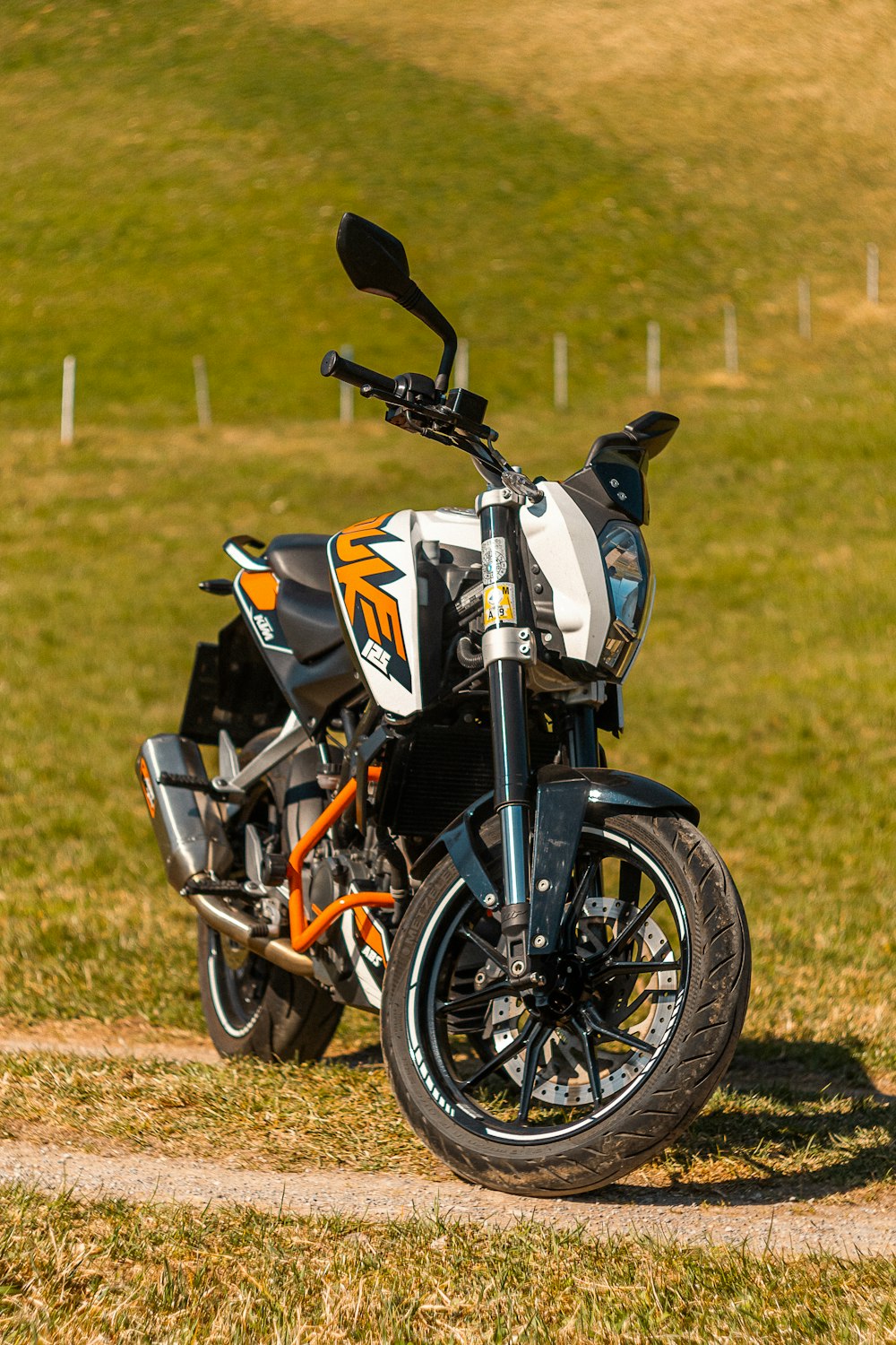 a motorcycle parked on the side of a dirt road