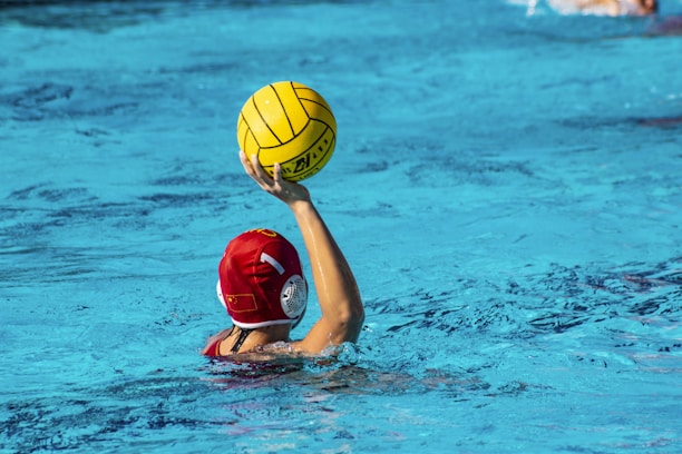 Photo of a sturdy water polo goal set up in a swimming pool on a sunny day.
