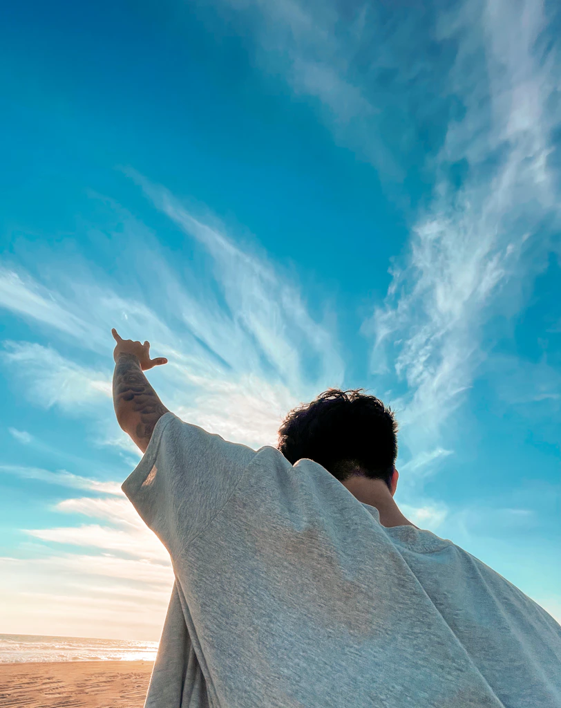 a man is flying a kite on the beach