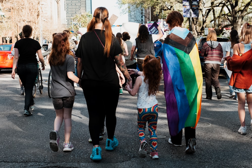 a group of people walking down a street