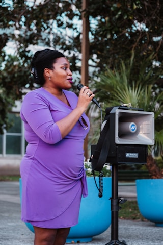 a woman standing in front of a microphone