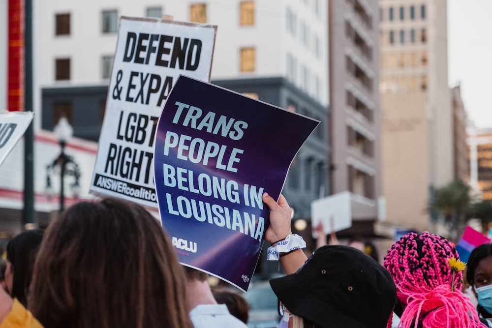 a group of people holding signs in the street