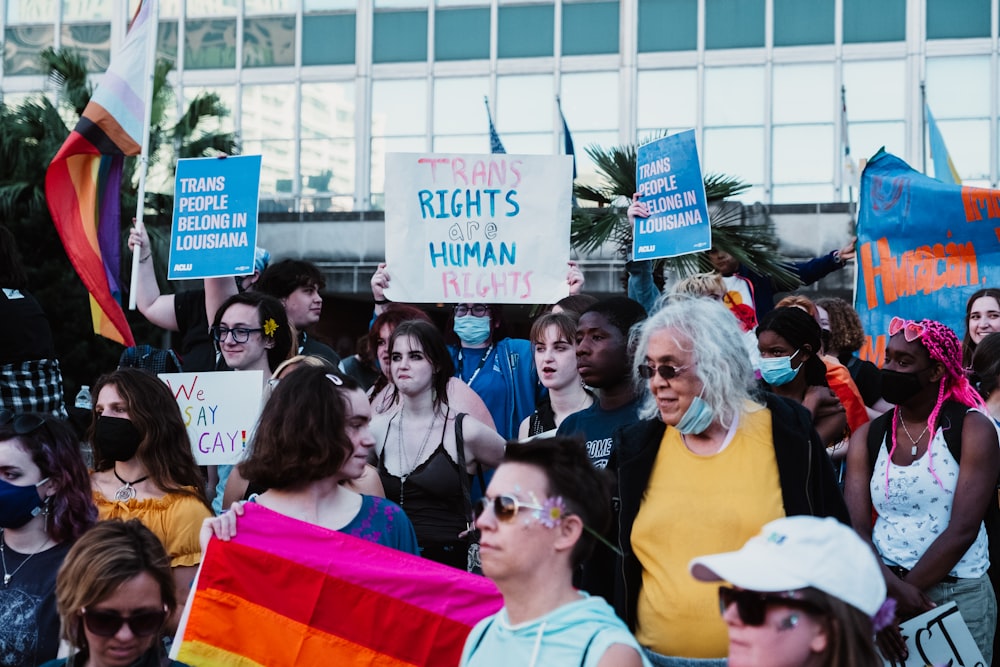 a crowd of people holding signs and flags