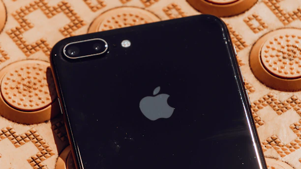 Close-up of a sleek iPhone displaying the sintetika app interface with gesture controls.