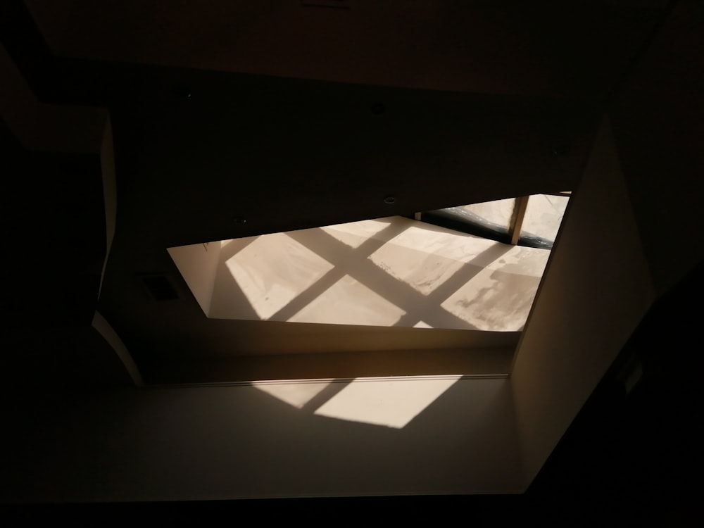 a room with a window and a light coming through it