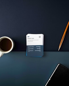 a cup of coffee and a notepad on a desk