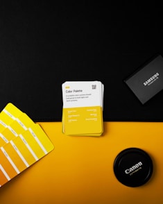 a yellow and white business card sitting on top of a yellow table