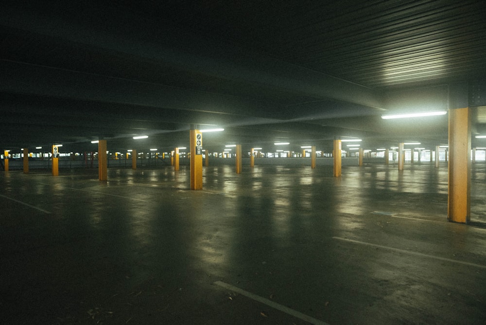 an empty parking lot at night with lights on
