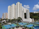 a tennis court surrounded by high rise buildings