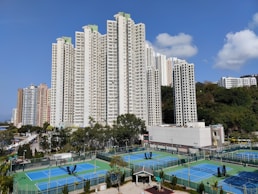 a tennis court surrounded by high rise buildings