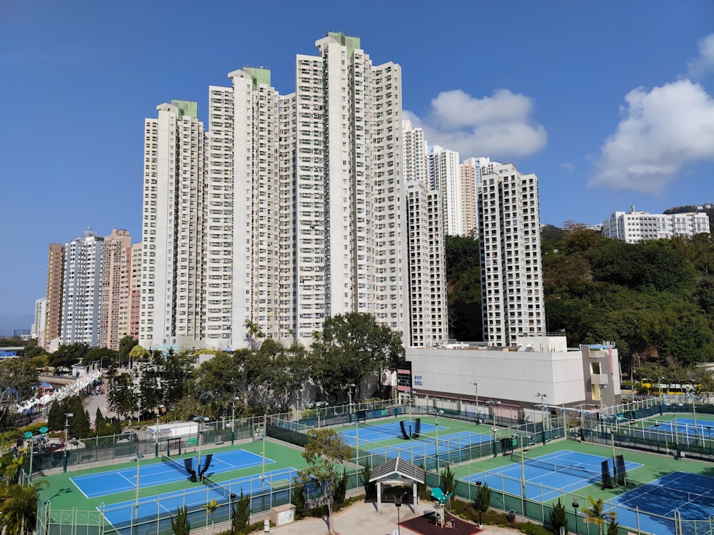 a tennis court surrounded by high rise buildings