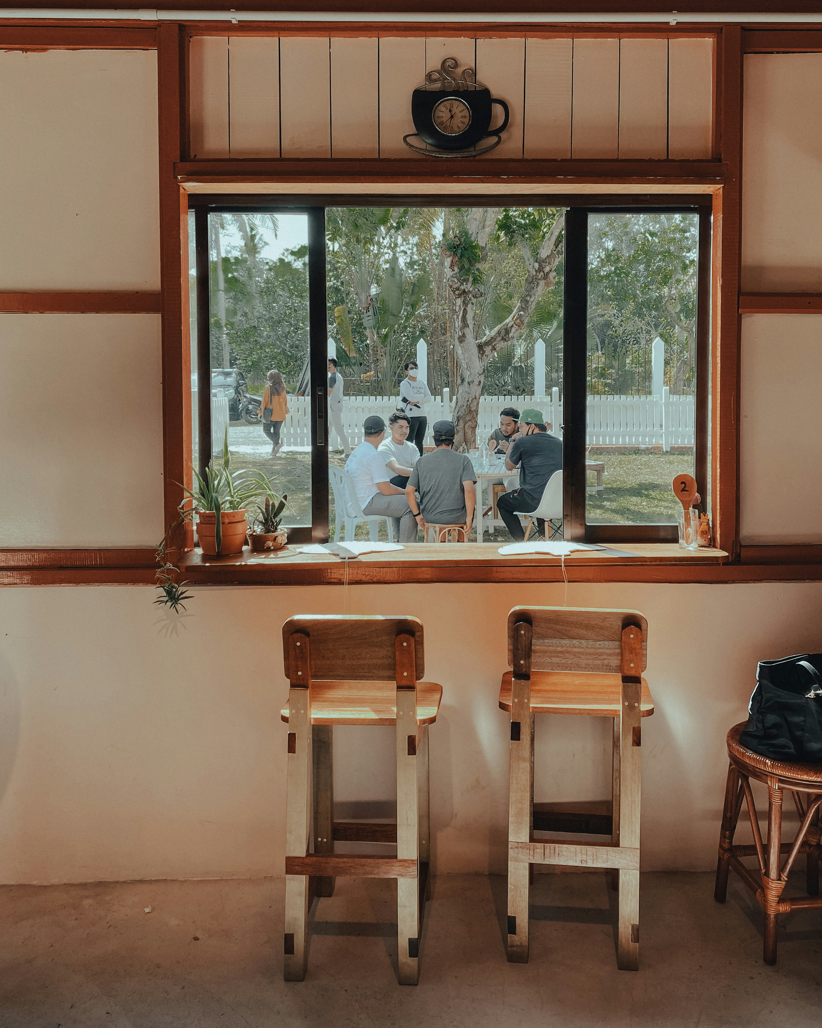 a couple of wooden chairs sitting in front of a window