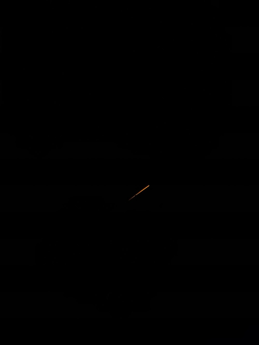 a plane is flying in the dark sky