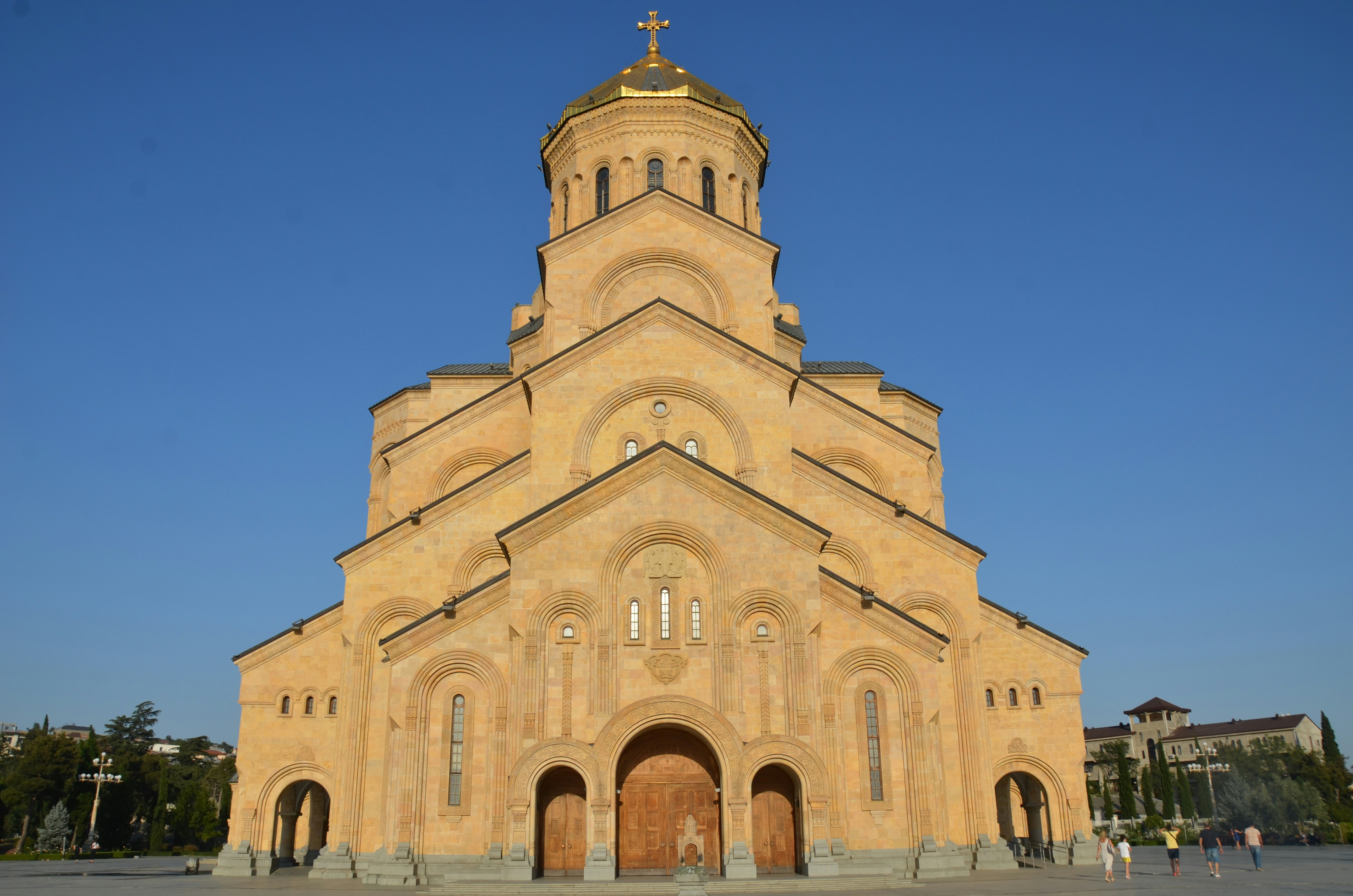 a large church with a golden steeple on a clear day