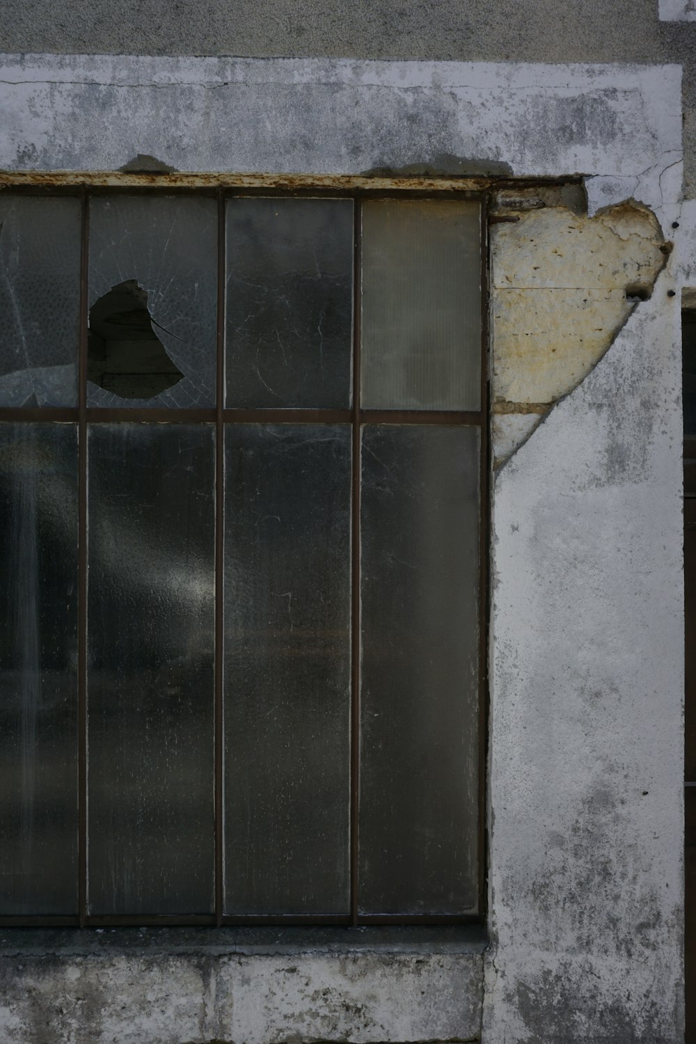a broken window on the side of a building