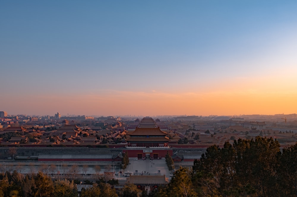 a view of a city from a hill at sunset