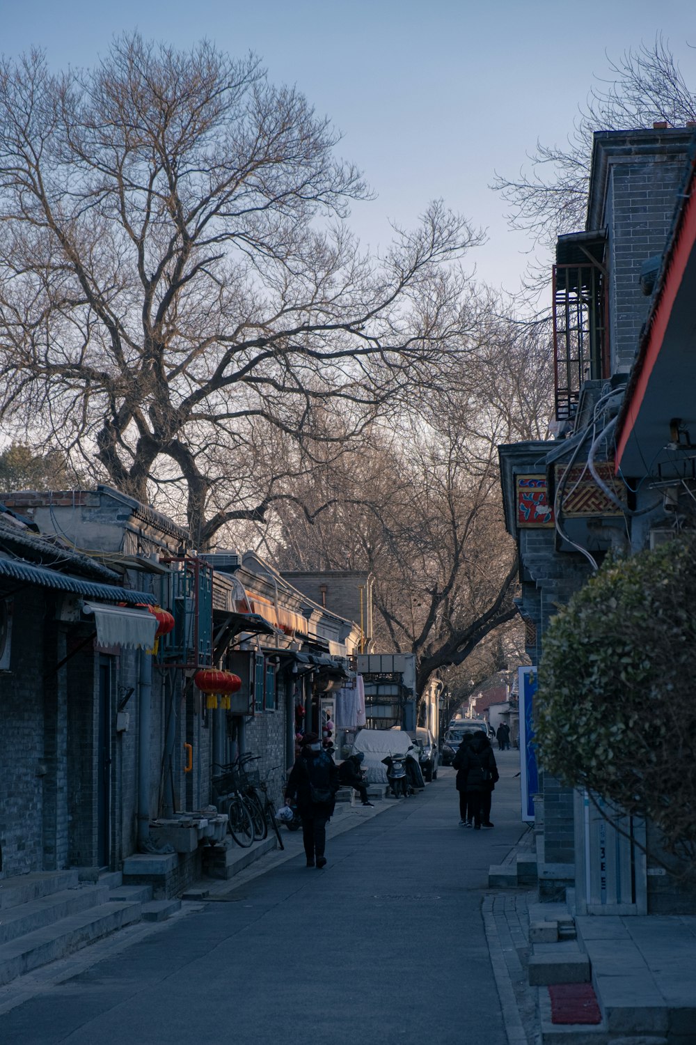 a couple of people walking down a street