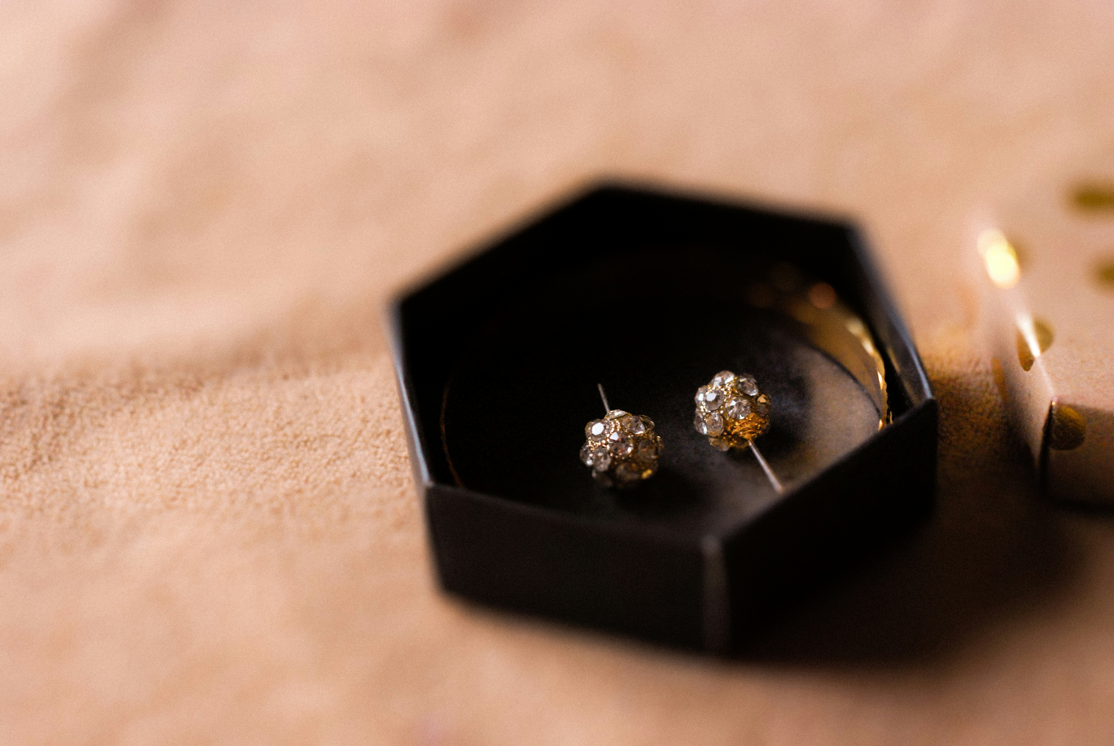 close-up shot of a pair of princess cut diamond studs in a box - mens princess cut diamond earrings