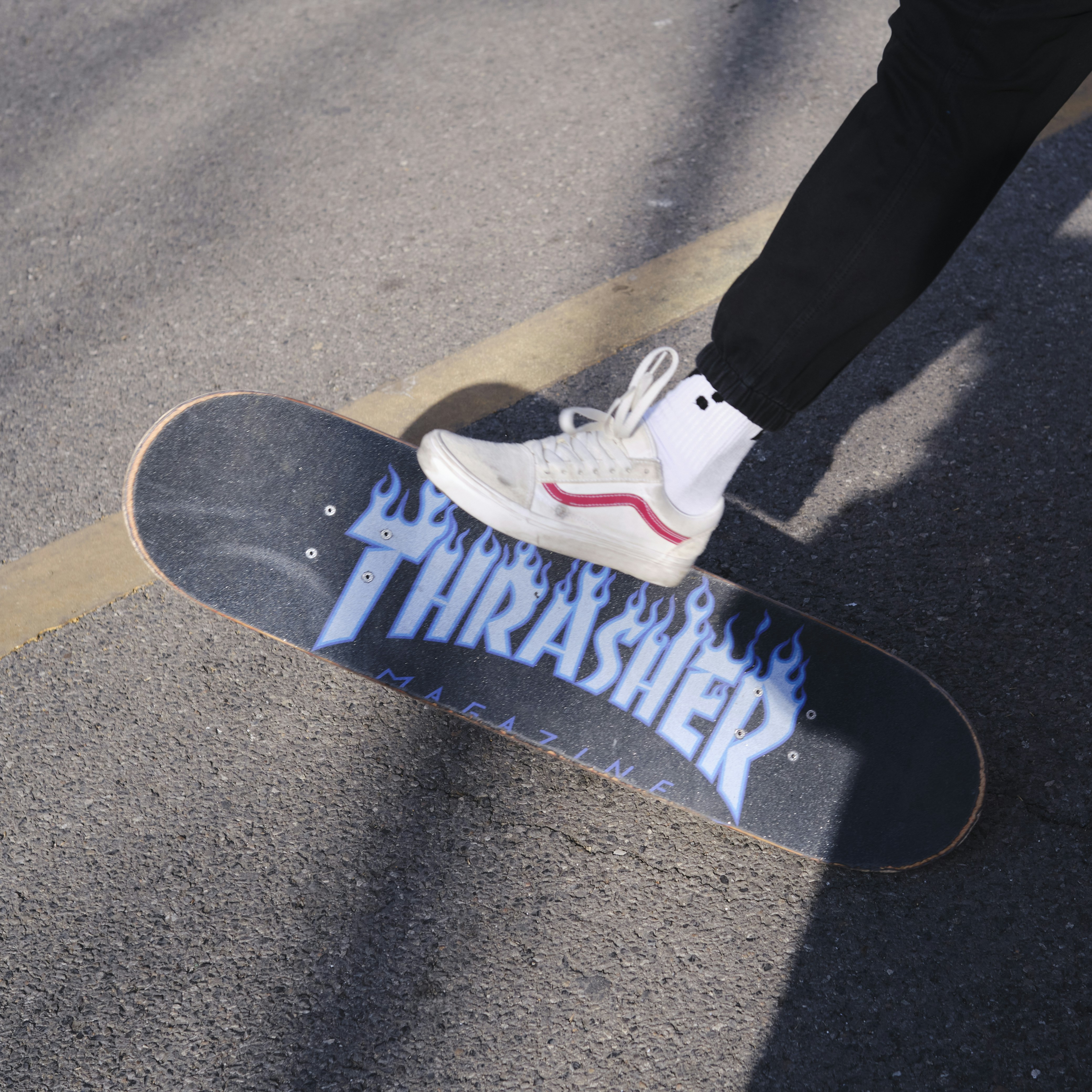 a person standing on top of a skateboard on a street