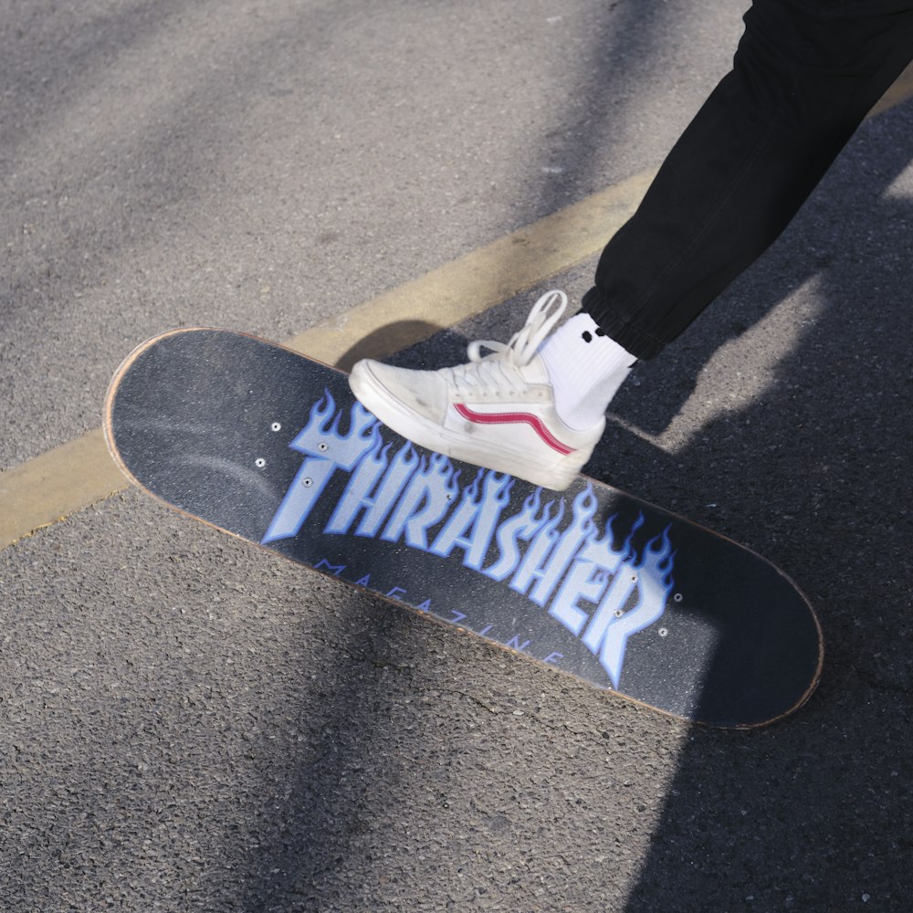 a person standing on top of a skateboard on a street