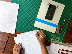 a person writing on a piece of paper